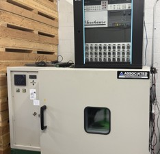 Figure 4. One of several temperature chambers at Morehouse used to check temperature compensation, with its 30-channel readout rack above it. Each load cell is read continuously while the chamber steps through its temperature points.